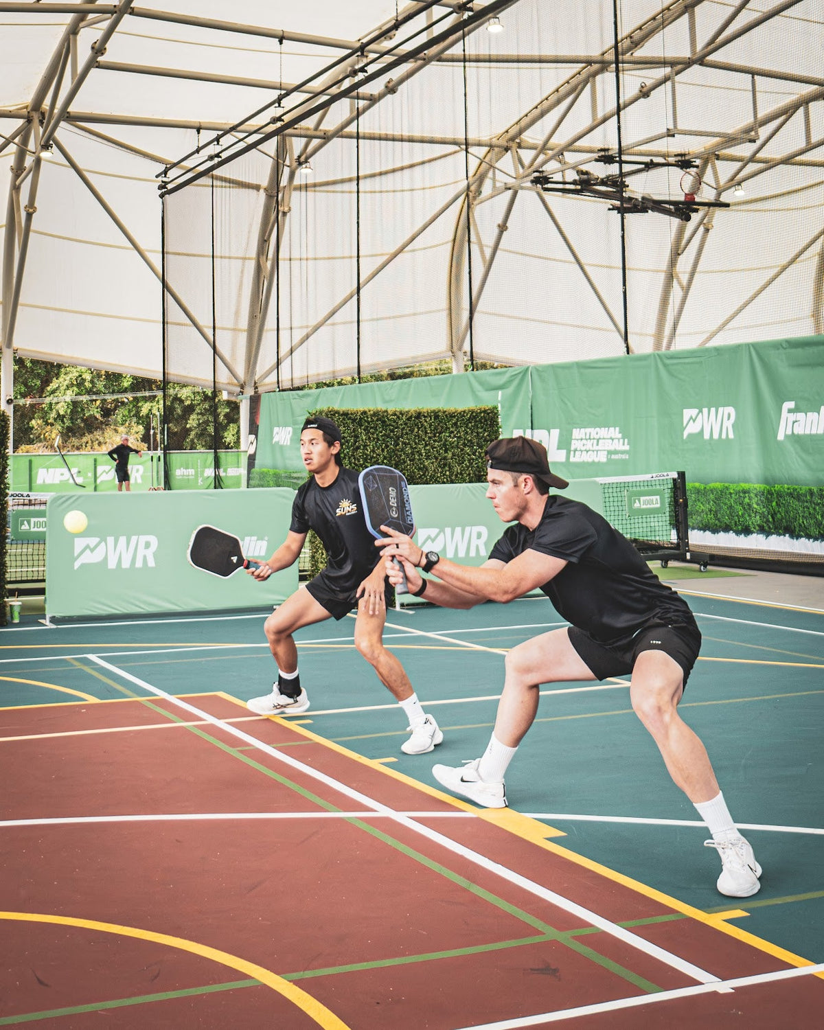 Ben and Chris playing pickleball — the Pickld founders on court