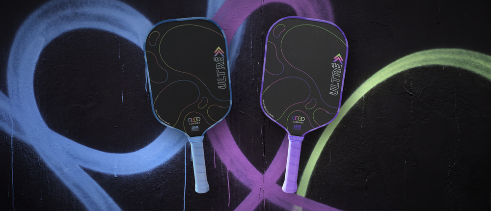 The 11SIX24 Ultre Jelly Bean 2 in Cornflower Blue and Cosmic Grape against a spray-painted wall