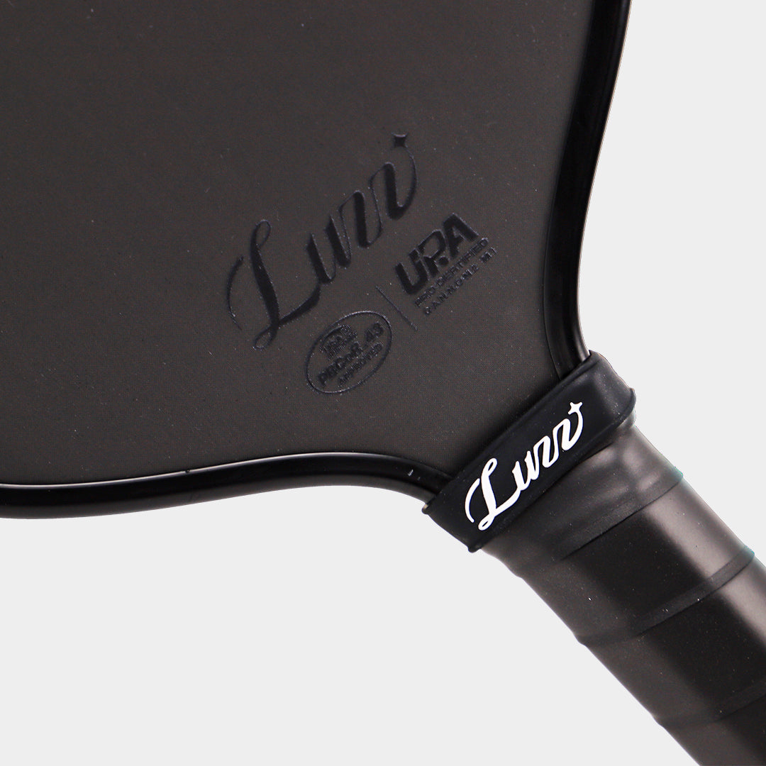 Luzz Cannon2 M1 pickleball paddle - throat detail with Luzz logo and UPA-A and USA Pickleball approval badges