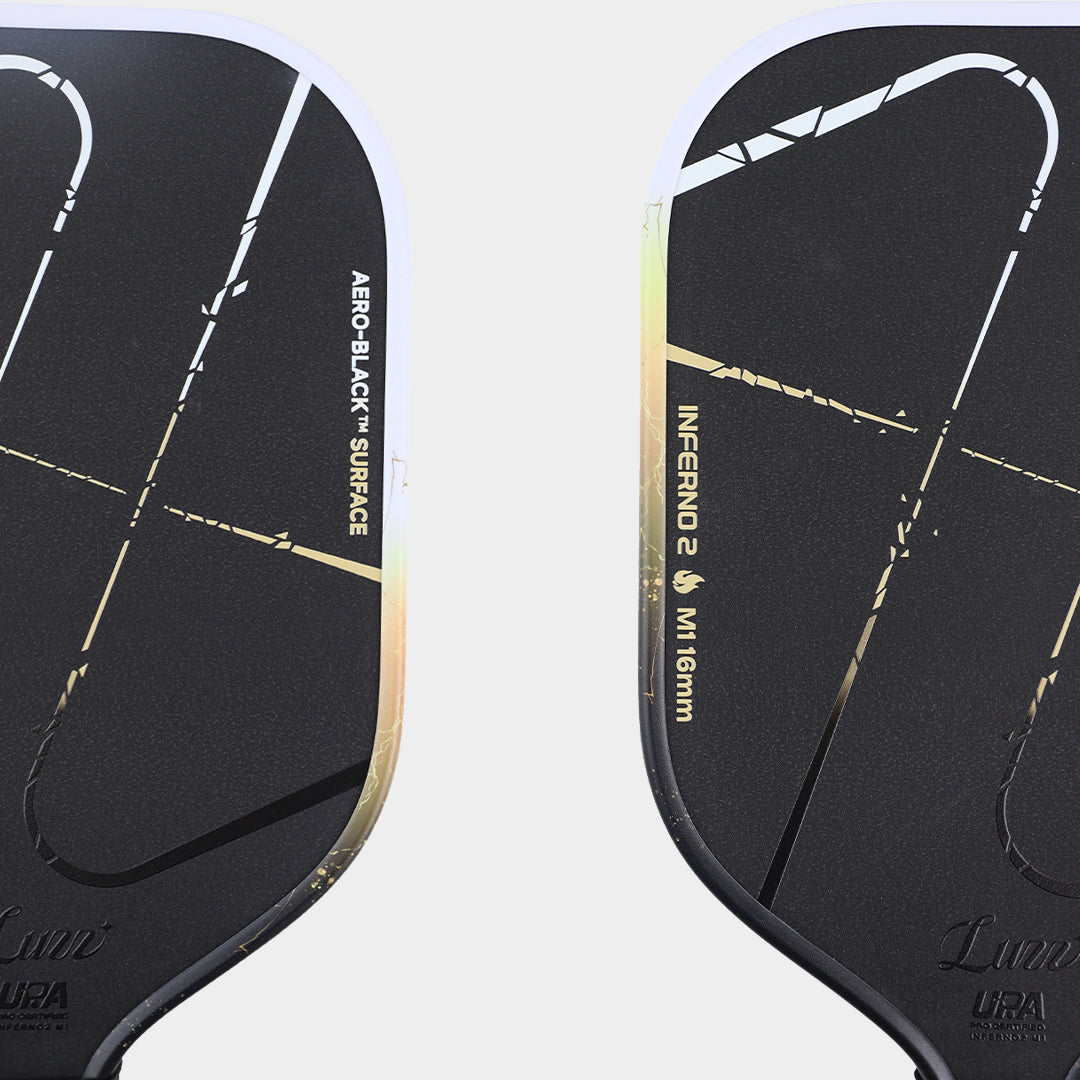 Luzz Inferno2 M1 Dawn pickleball paddle - surface macro showing the Aero-Black silicon carbide face and UPA-A badge