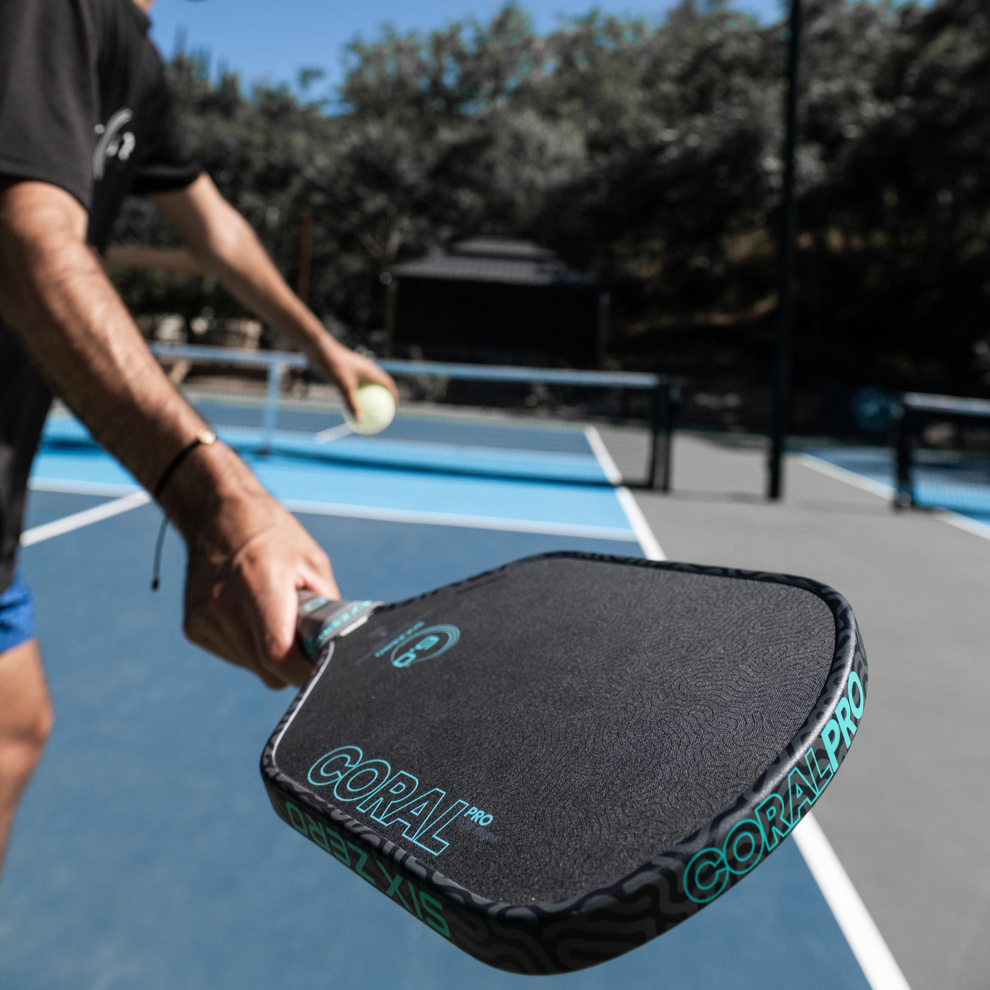 Six Zero Coral Pro pickleball paddle — in hand