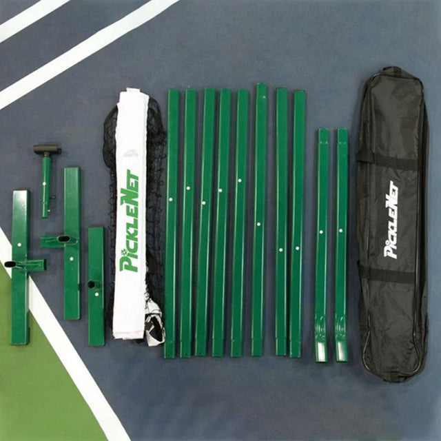Everything in the PickleNet box laid out: green oval poles, T shaped end bases, centre support, net with centre strap, and the carry bag