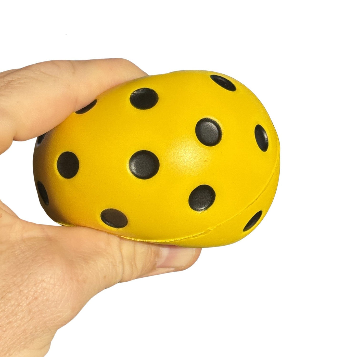 Pickld Silent Pickleball compressed in hand showing soft EVA foam construction