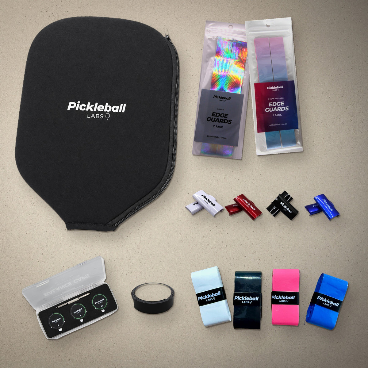 Pickleball Labs Ultimate Paddle Kit flat-lay: paddle cover, edge guards, weighted clips, balance caps, tungsten tape and FlexTac overgrips in every colour option