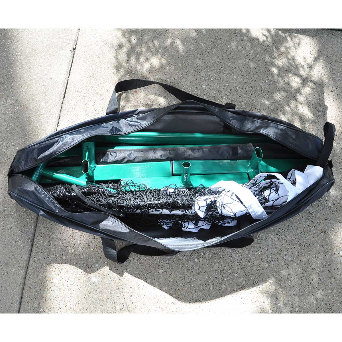 PickleNet carry bag open, showing the green powder coated oval poles and folded net inside