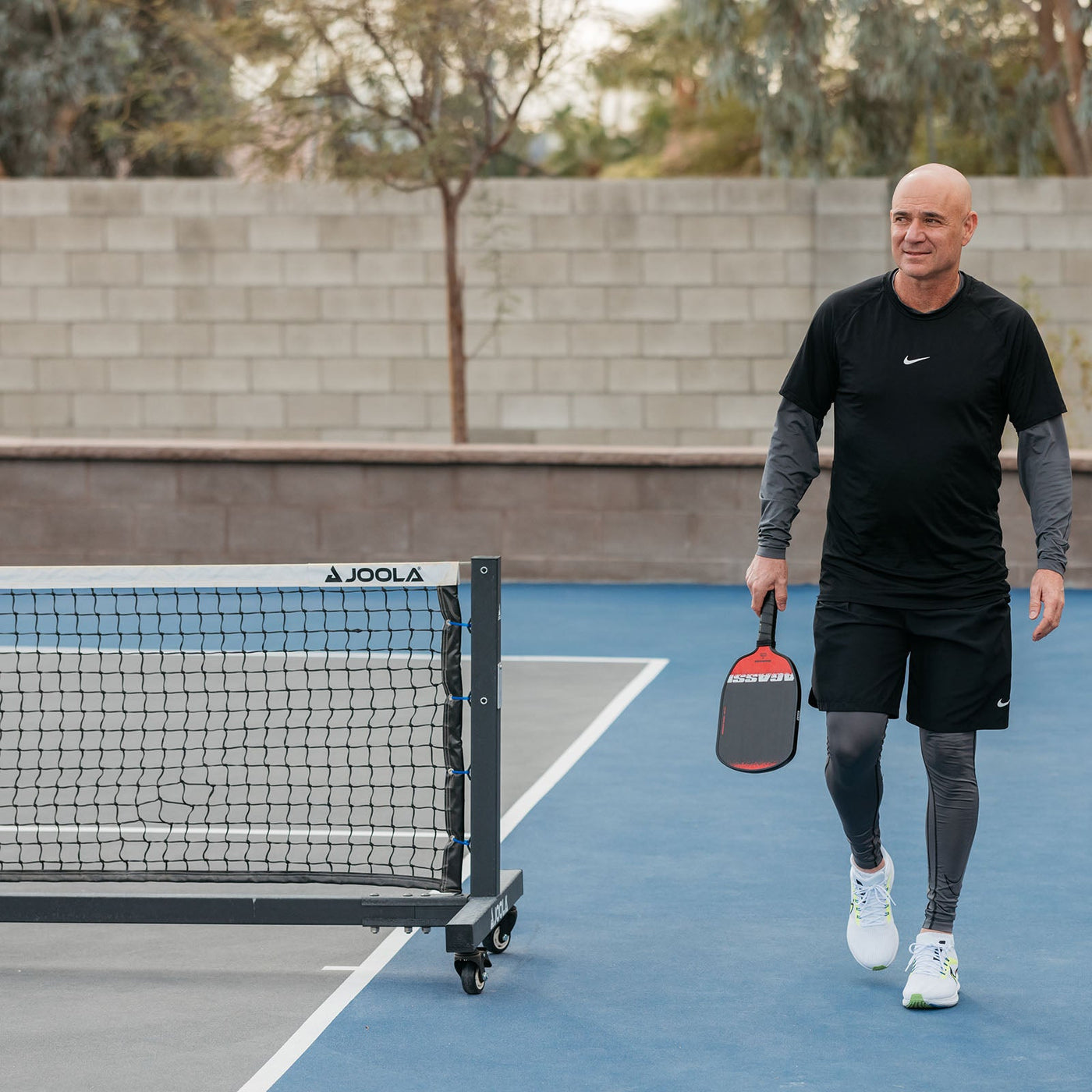 JOOLA Pro Pickleball Net (C) set up on an outdoor pickleball court